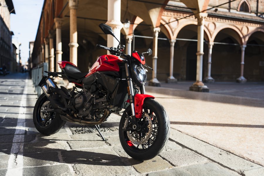 Ducati Monster + parked under a Bologna portico